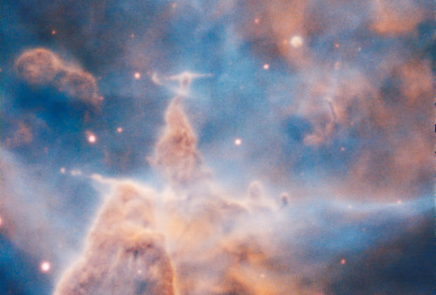 This majestic pillar of the Carina Nebula (NGC 3372) is a 3-light-year-tall cloud of gas and dust that is being eaten away by the brilliant light from stars both in its surroundings and inside the cloud itself. The European Southern Observatory's Very Large Telescope in Chile created the image with the Multi Unit Spectroscopic Explorer (MUSE) instrument. Credit: ESO/A. McLeod