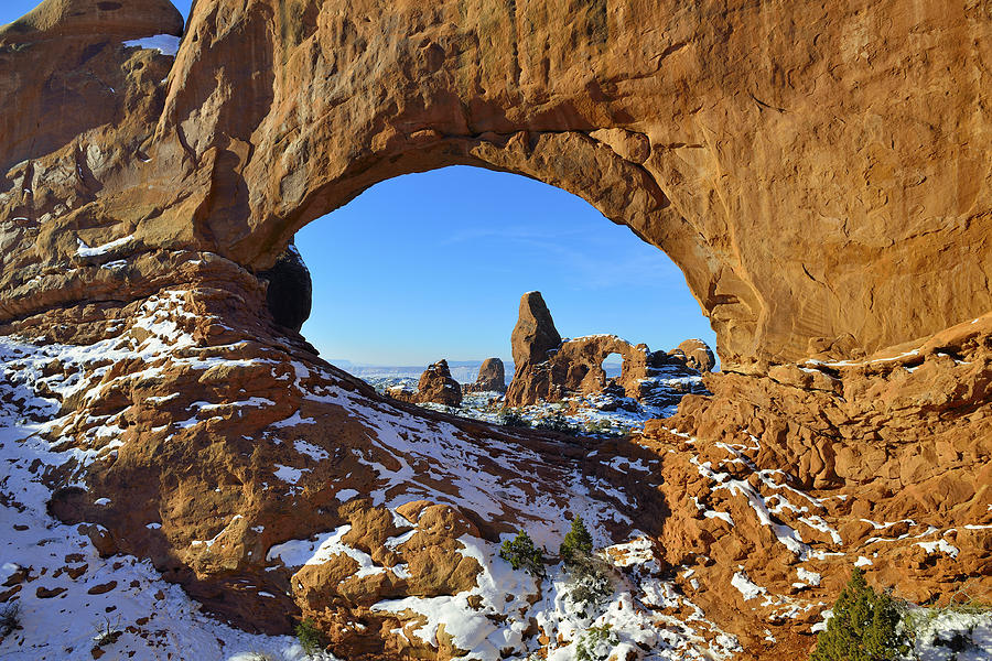 turret-arch-seen-through-north-window-arch-in-arches-national-park-utah-in-winter-alexey-kamenskiy